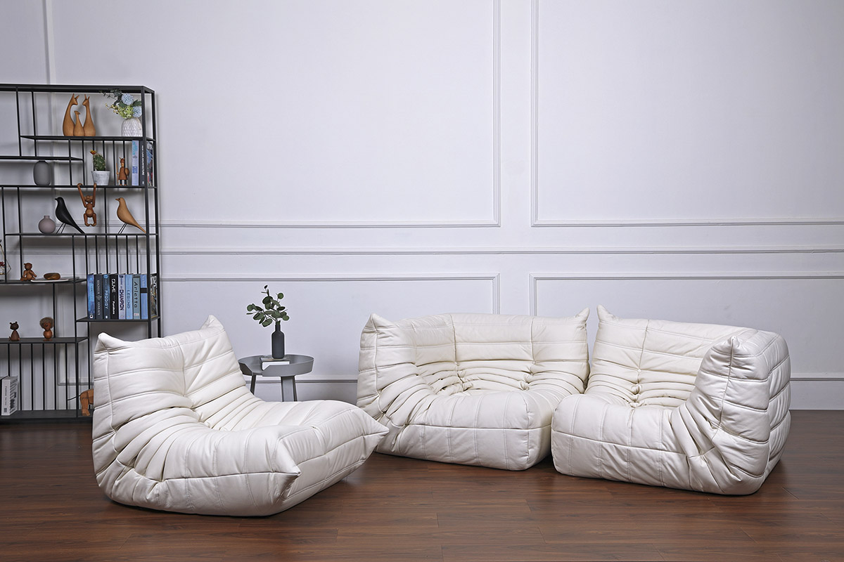 Combination of white aniline leather togo chair without armrests, togo chair with armrests, and a togo corner sofa