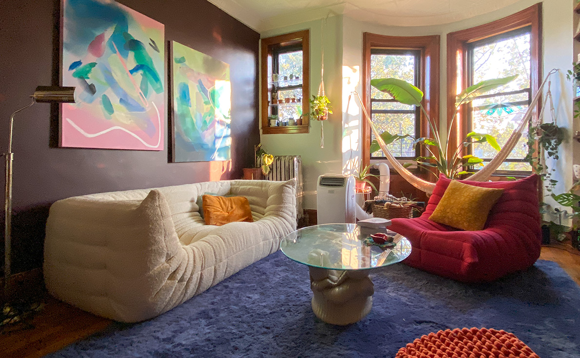 Cream Boucle fabric togo sofa with armrest and a pink togo chair